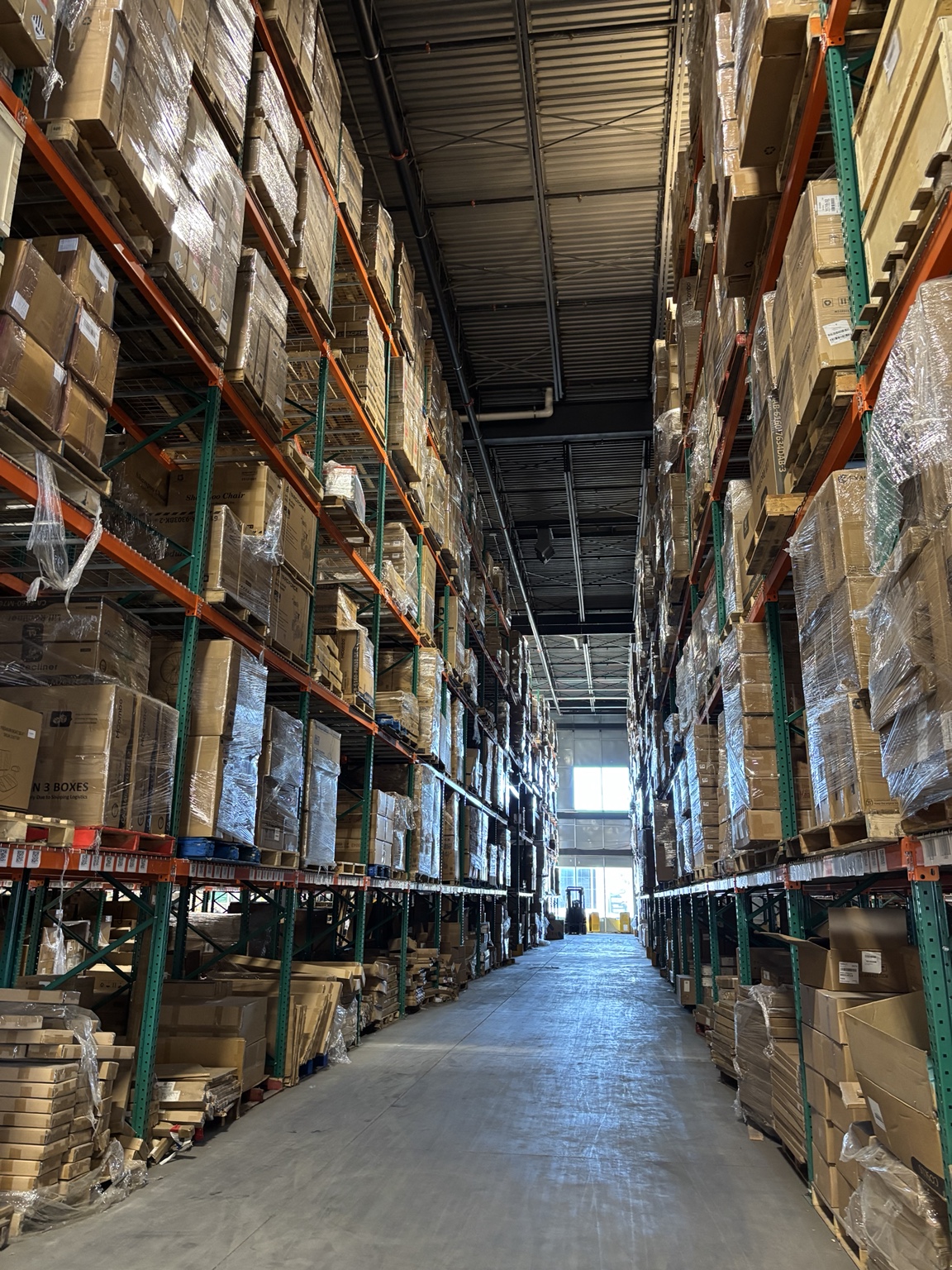 Pallets stored along a warehouse aisle